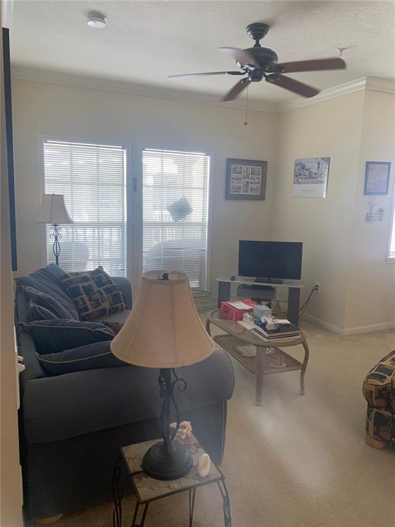 571 Water Street, Unit 571 Celebration, FL 34747 - Photo 6 of 26 a living room with furniture and a flat screen tv