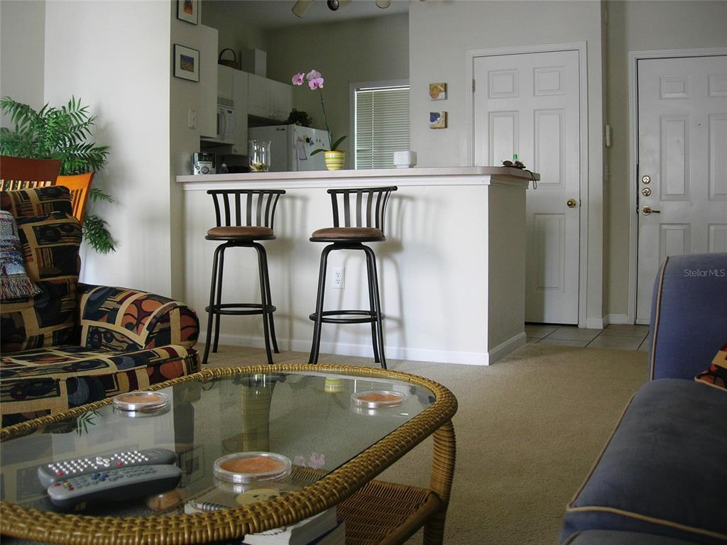 571 Water Street, Unit 571 Celebration, FL 34747 - Photo 9 of 26 a view of dining room and kitchen with furniture