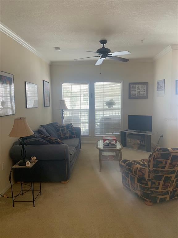 571 Water Street, Unit 571 Celebration, FL 34747 - Photo 10 of 26 a living room with furniture and a large window