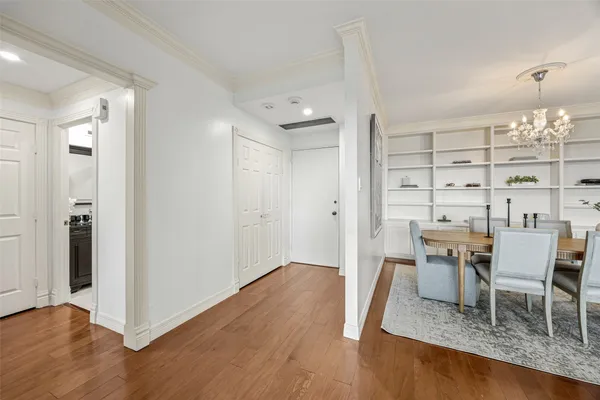 a dining room with furniture and wooden floor
