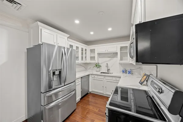 a kitchen with a sink stainless steel appliances and cabinets