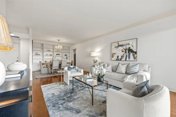 a living room with furniture and view of kitchen