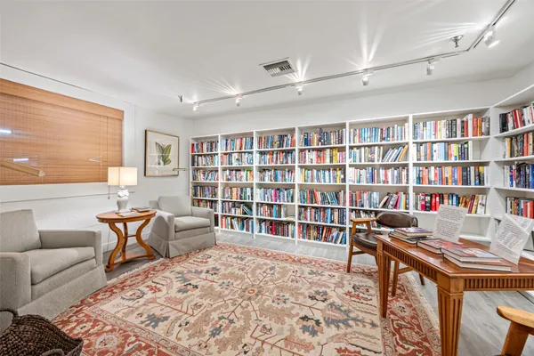 a living room with furniture and a book shelf