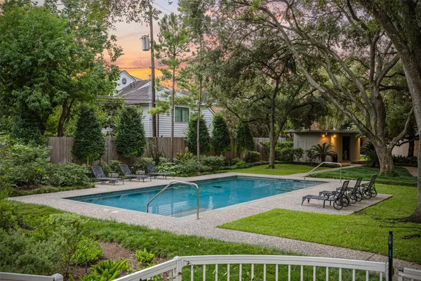 a view of a house with swimming pool and sitting area