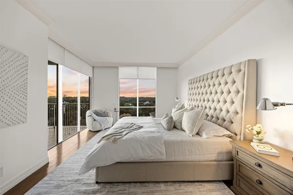 a bedroom with a large bed and a large window