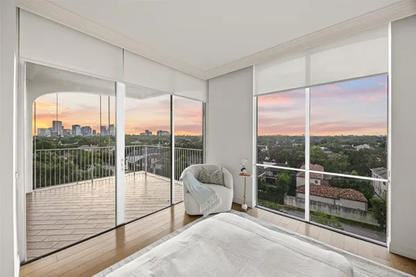 a room with a bed and glass door