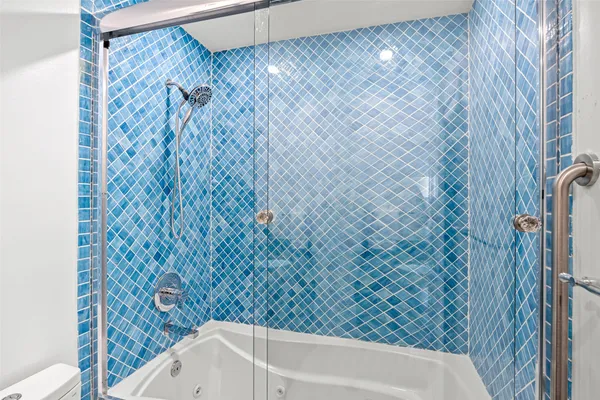 a bathroom with a bathtub and shower