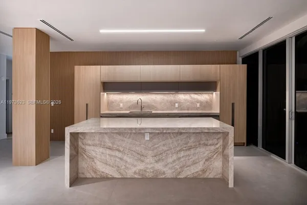 a kitchen with stainless steel appliances granite countertop a sink and a refrigerator