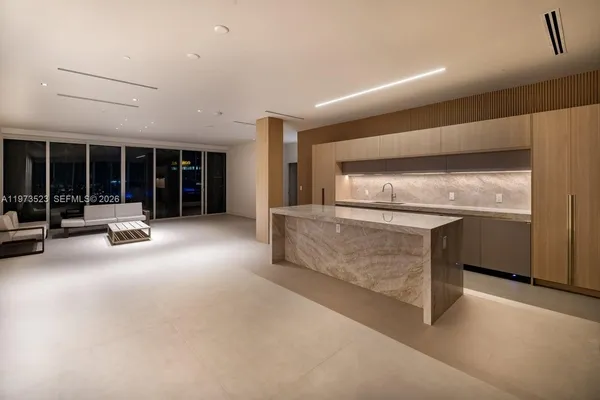 a kitchen with stainless steel appliances granite countertop a sink and a refrigerator