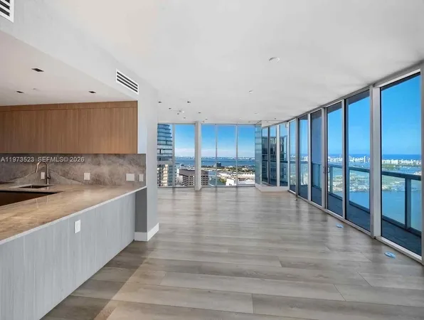 a kitchen with stainless steel appliances granite countertop a sink and a refrigerator