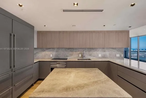 a view of a kitchen with furniture and wooden floor