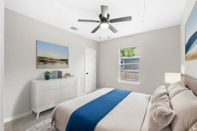 a bedroom with a bed and a window