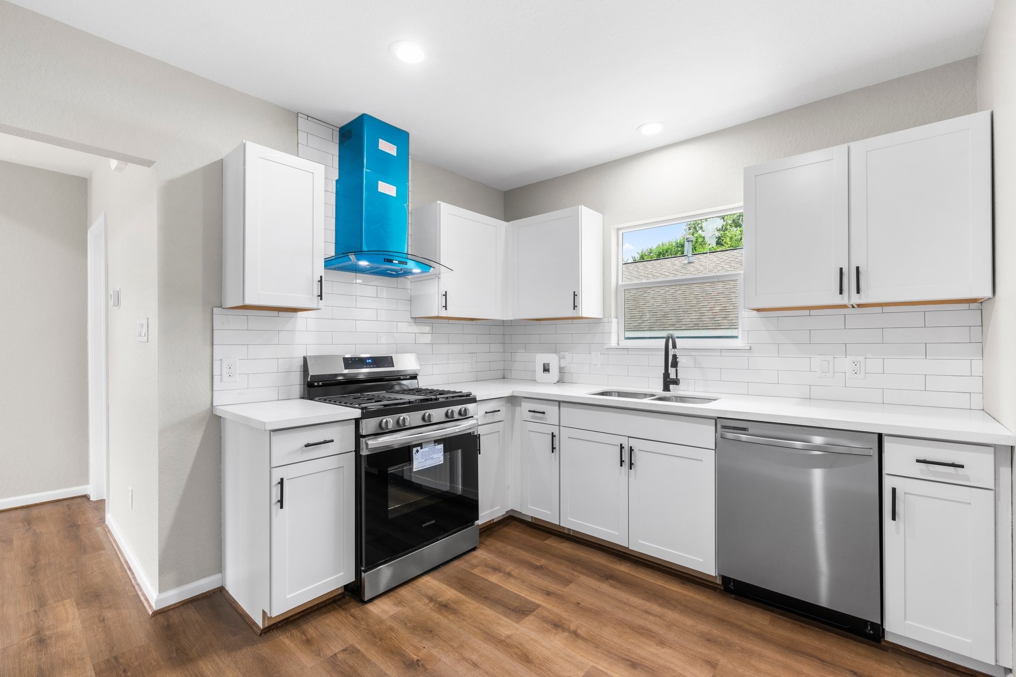 3106 Michigan Street Baytown, TX 77520 - Photo 6 of 14 a kitchen with a sink cabinets and stainless steel appliances