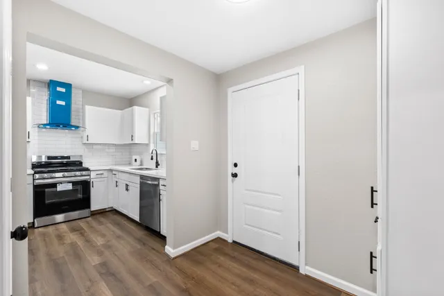 a kitchen with a stove top oven and cabinets