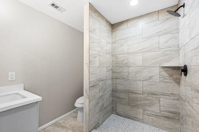 a bathroom with a sink toilet and shower