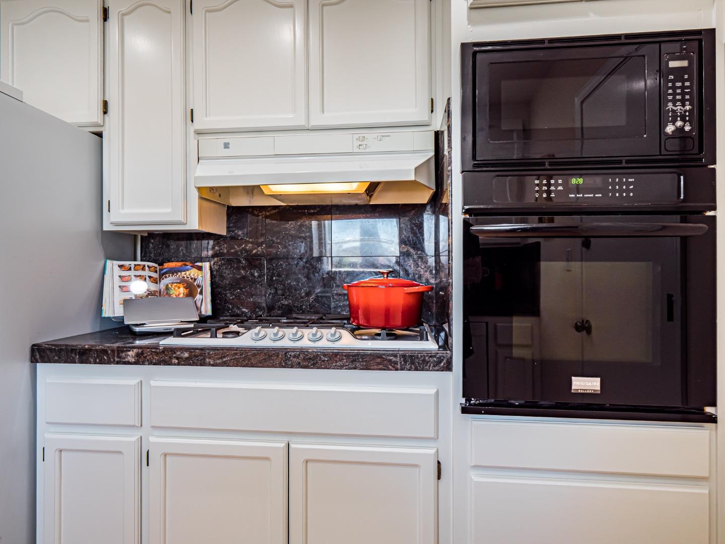 237 Siesta Drive Aptos, CA 95003 - Photo 15 of 43 a kitchen with stainless steel appliances granite countertop a stove and a microwave with cabinets
