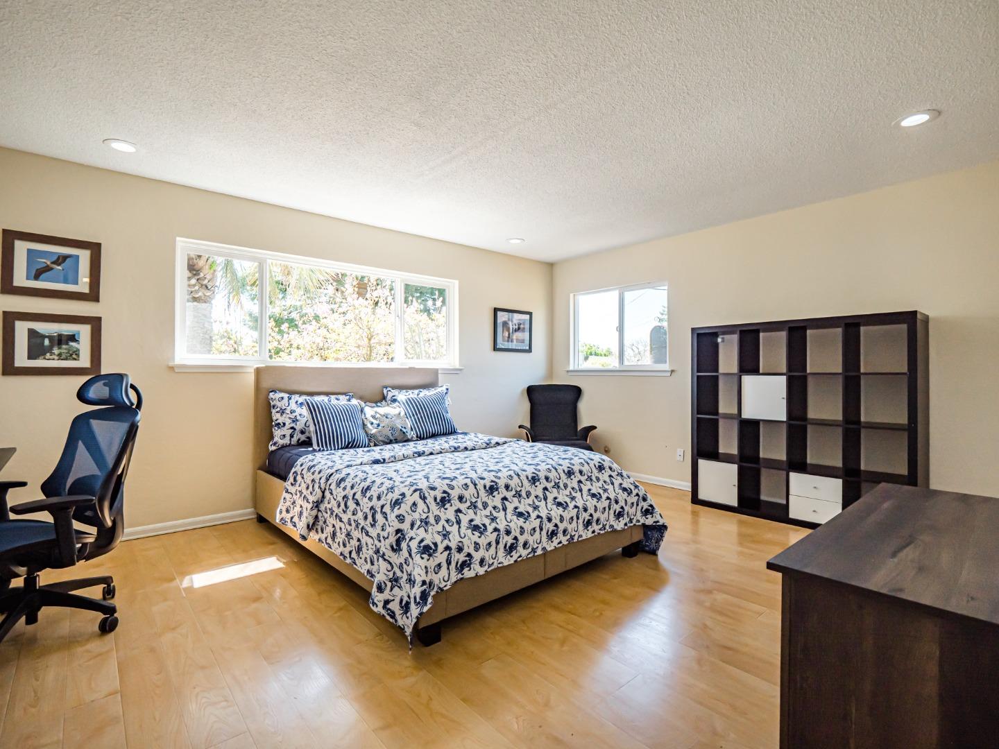 237 Siesta Drive Aptos, CA 95003 - Photo 24 of 43 a bedroom with a bed a dresser and a large window