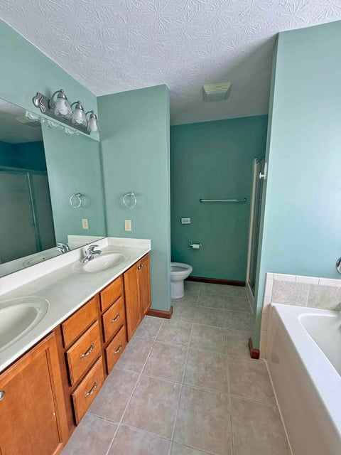 541 North Point Troy, OH 45373 - Photo 14 of 23 This primary bathroom features a double vanity and a built-in tub for ultimate relaxation.