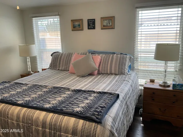 a bedroom with a large bed and a window