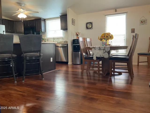 a dining room with furniture and wooden floor