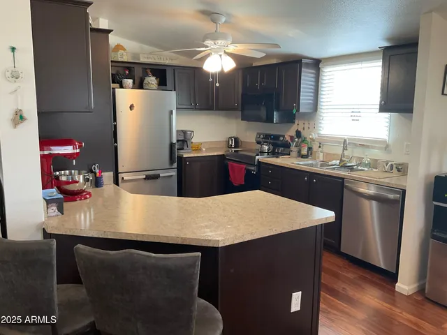 a kitchen with a table chairs refrigerator and cabinets