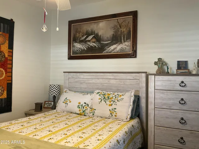 a bed room with a bed and a painting on the wall
