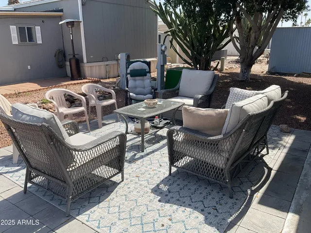 a view of a chairs and table in backyard