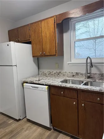 a kitchen with a sink a refrigerator and window