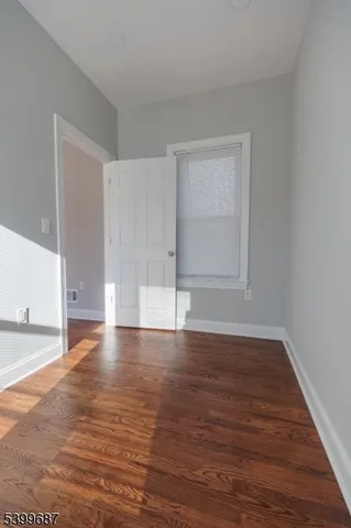 a view of an empty room and wooden floor