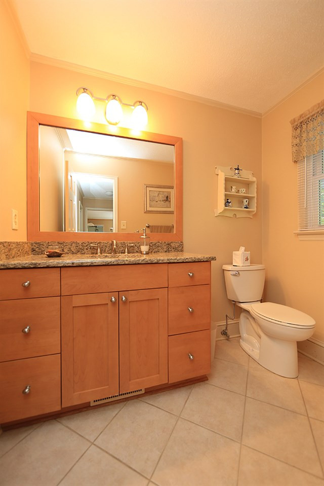 7905 Hardwick Drive Raleigh, NC 27615 - Photo 11 of 26 The half bath has tall vanity, tile floors! Updated Half Bath