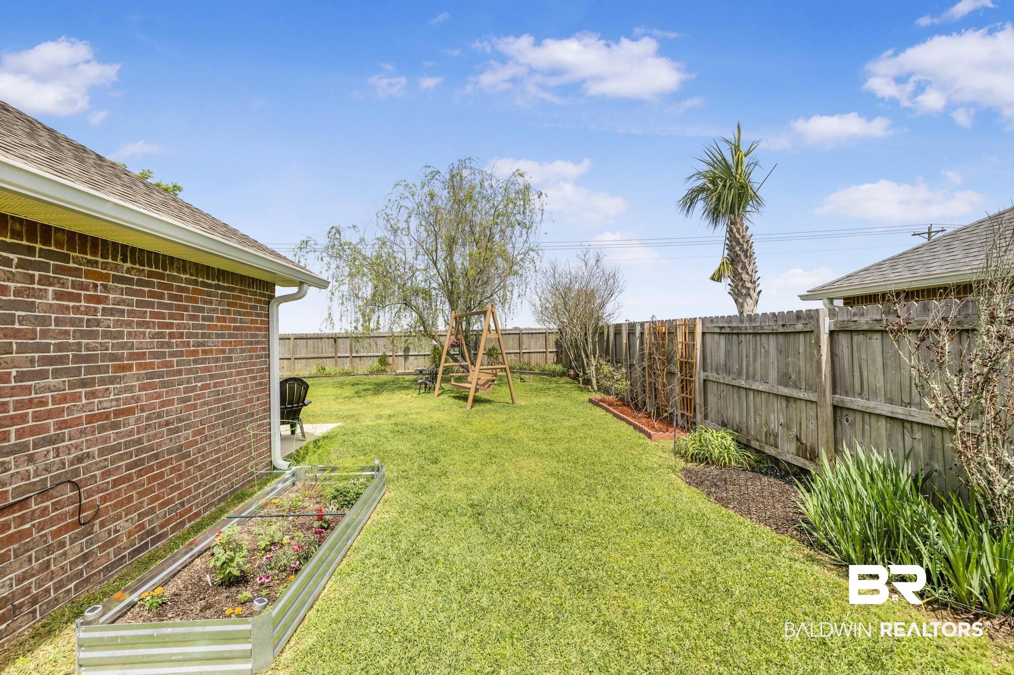 16545 Cold Mill Loop Foley, AL 36535 - Photo 33 of 48 View of yard with a fenced backyard and a vegetable garden