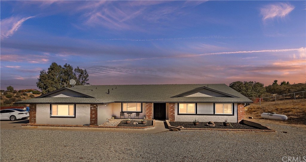 10782 Ranchero Road Oak Hills, CA 92344 - Photo 1 of 1 a front view of a house with a yard