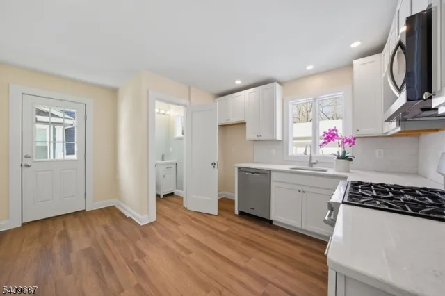 a view of a room with wooden floor and window