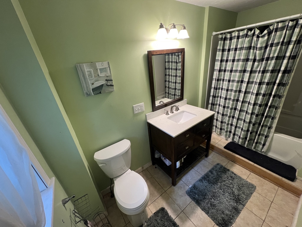 40 Chestnut Street Milford, MA 01757 - Photo 11 of 19 a living room with furniture a rug and a window