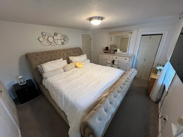 a bedroom with a bed and a walk in closet