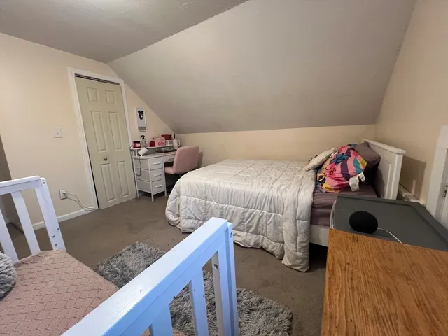 a bedroom with a bed and cabinets