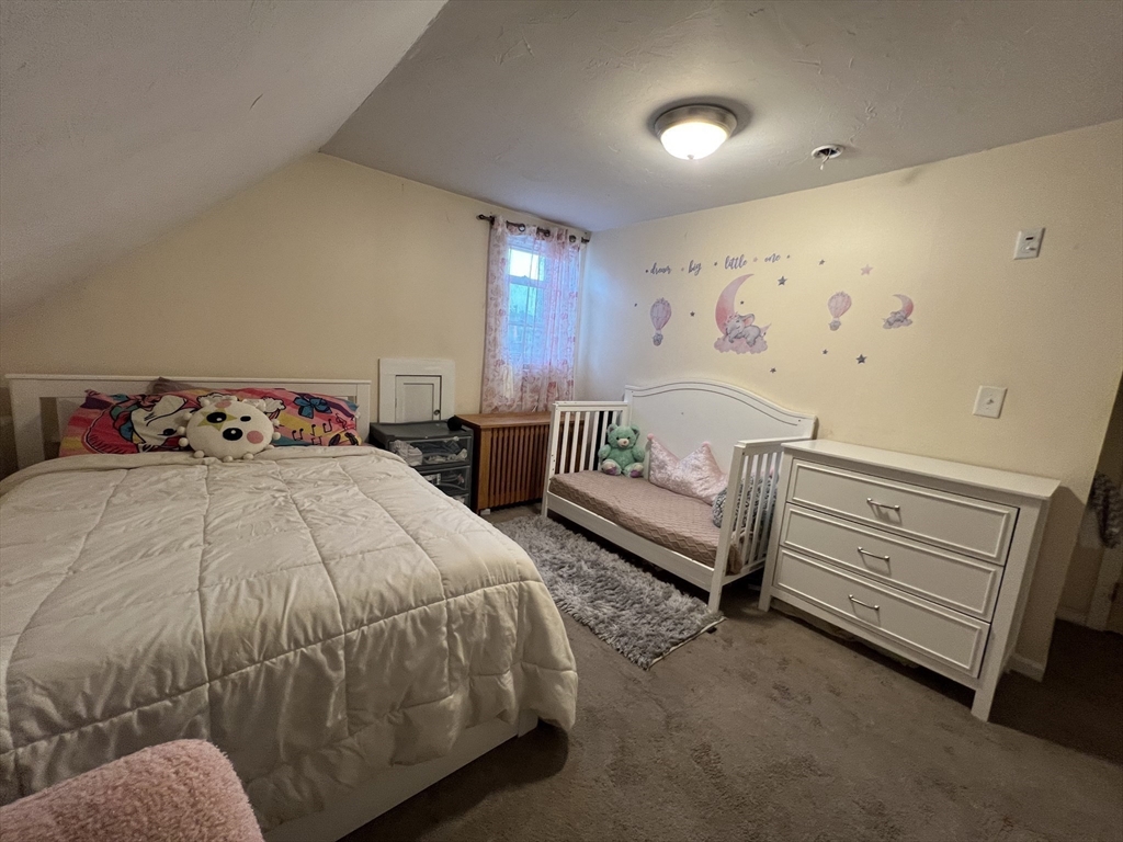 40 Chestnut Street Milford, MA 01757 - Photo 17 of 19 a bedroom with a bed and a window