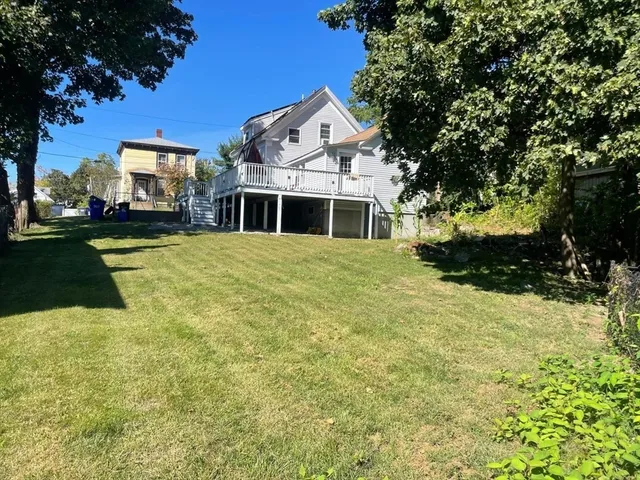 a front view of a house with a yard garage and outdoor seating