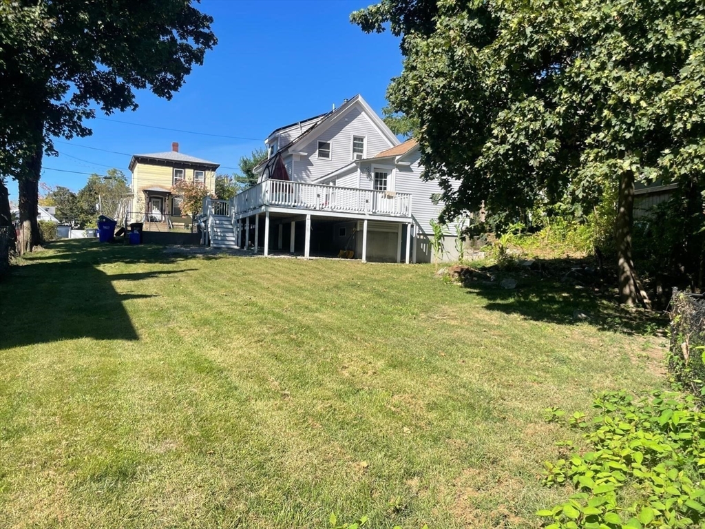 40 Chestnut Street Milford, MA 01757 - Photo 19 of 19 a front view of a house with a yard garage and outdoor seating