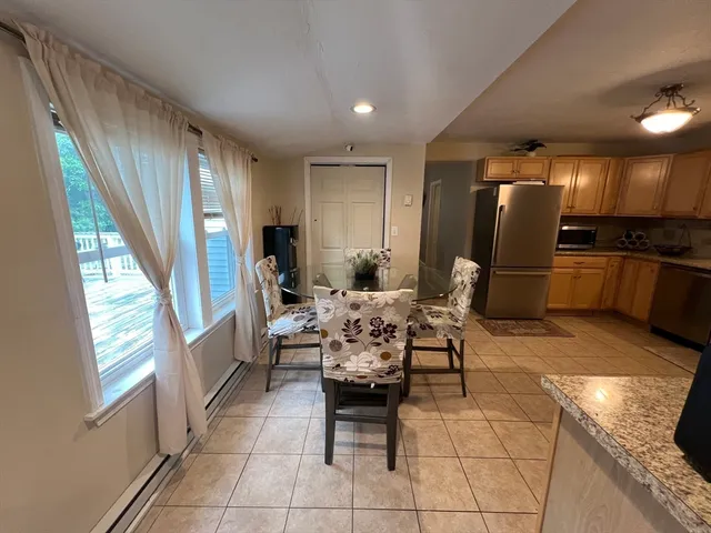 a dining room with furniture and a kitchen