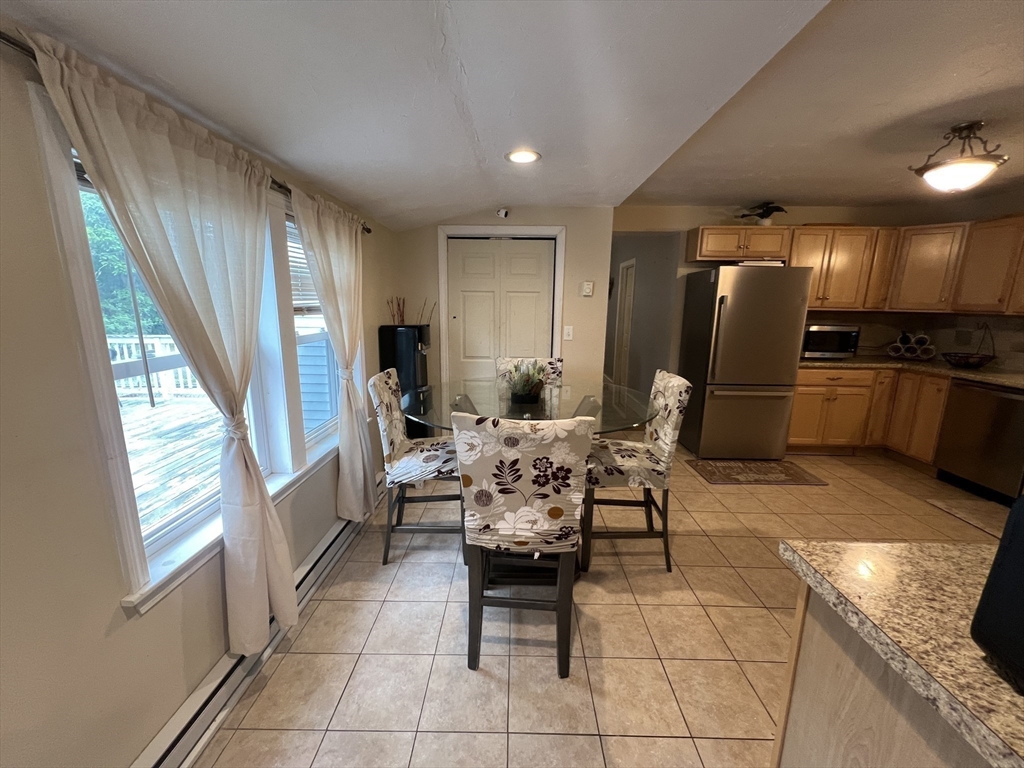 40 Chestnut Street Milford, MA 01757 - Photo 7 of 19 a dining room with furniture and a kitchen