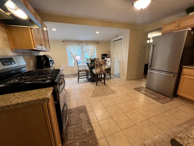a kitchen with stainless steel appliances a refrigerator sink and cabinets