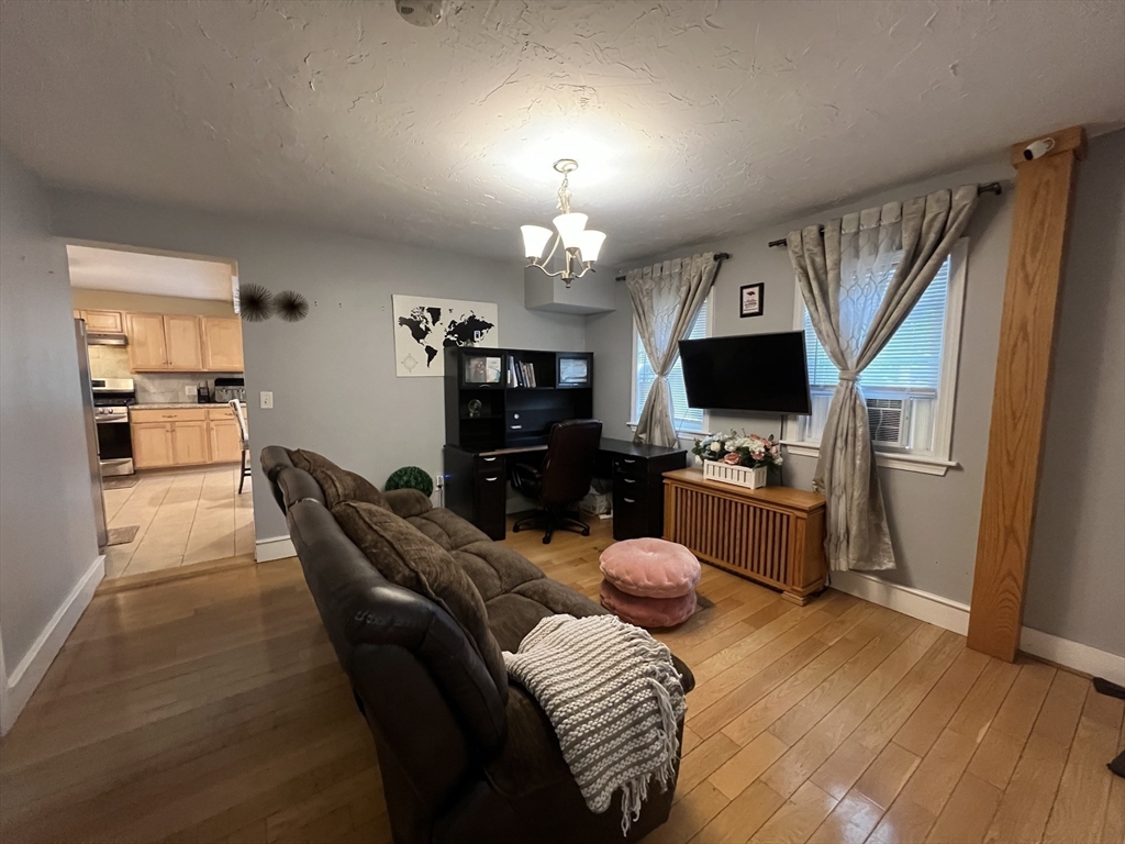 40 Chestnut Street Milford, MA 01757 - Photo 9 of 19 a living room with furniture a fireplace and a flat screen tv