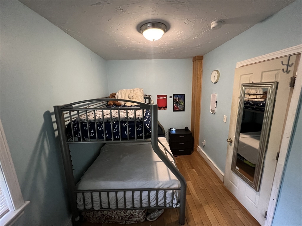 40 Chestnut Street Milford, MA 01757 - Photo 10 of 19 a view of a hallway with wooden floor and staircase