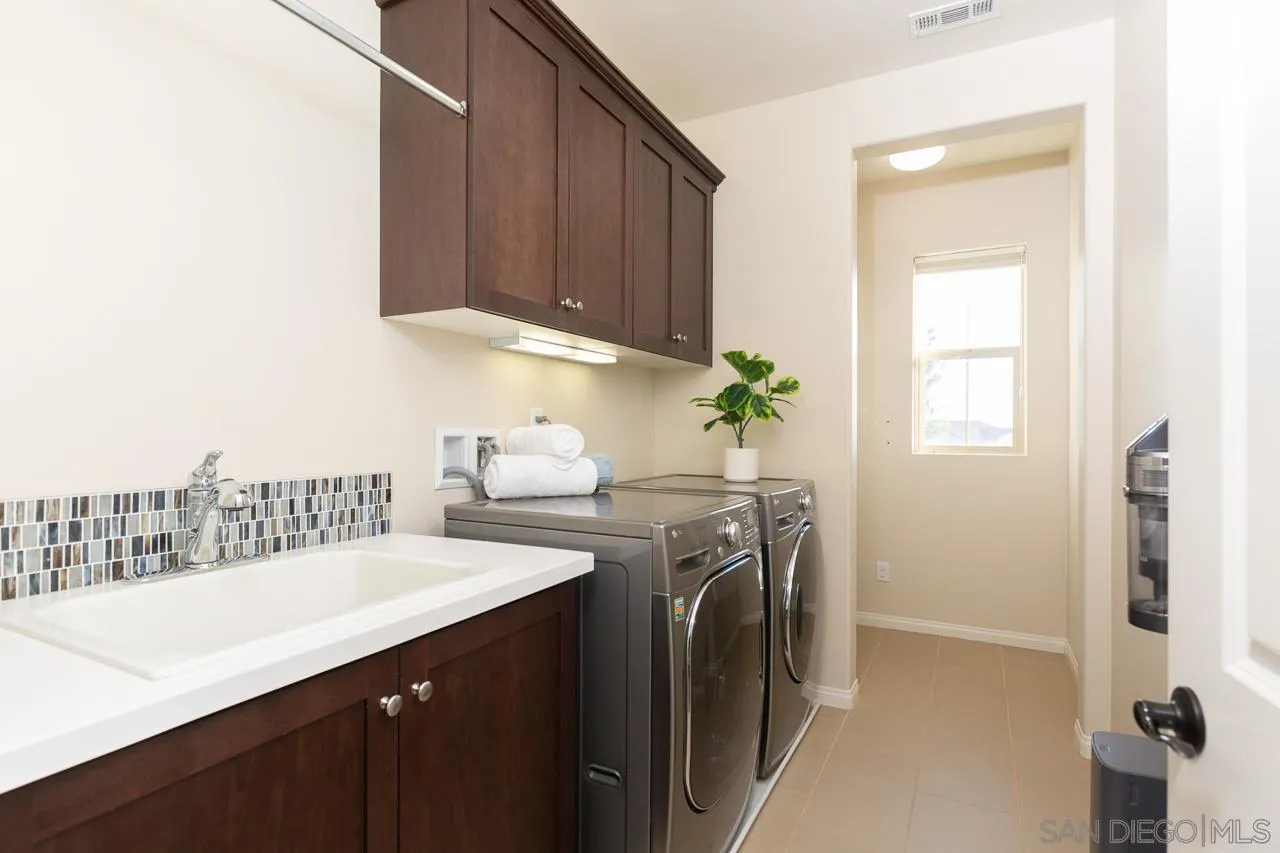 15622 Potomac Ridge Road San Diego, CA 92127 - Photo 26 of 49 a kitchen with a sink a stove and cabinets