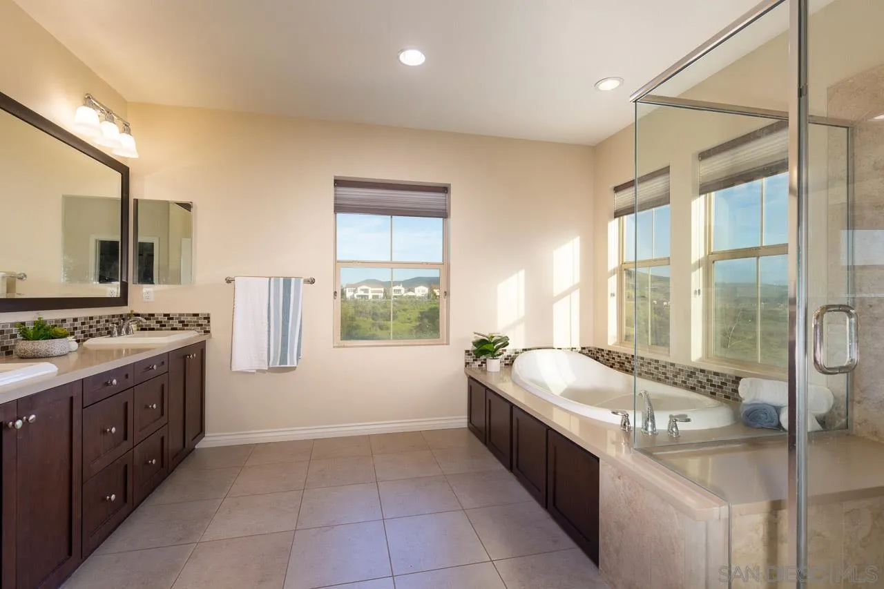 15622 Potomac Ridge Road San Diego, CA 92127 - Photo 28 of 49 a large spacious bathroom with a granite countertop tub sink and mirror