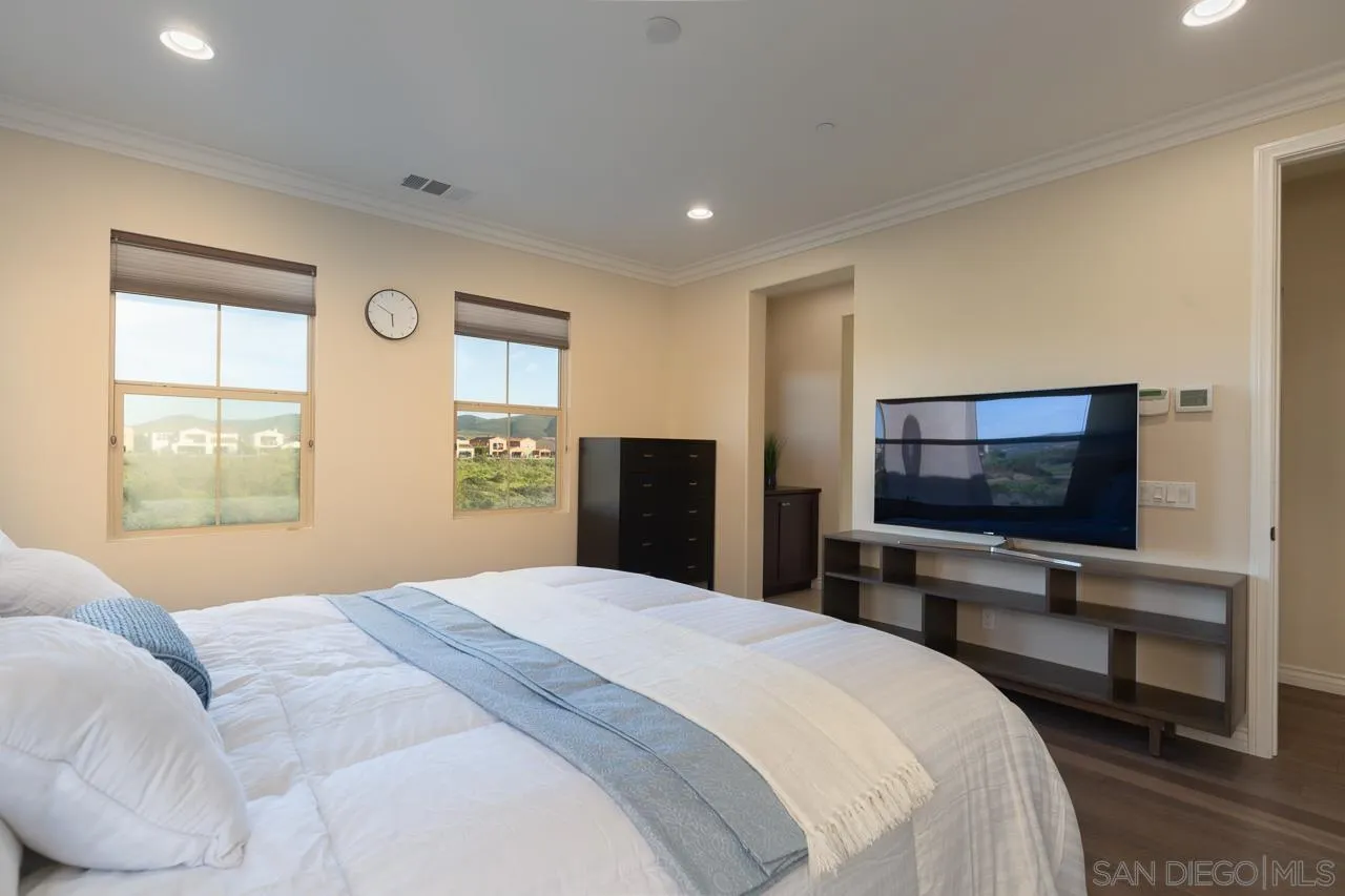15622 Potomac Ridge Road San Diego, CA 92127 - Photo 29 of 49 a bedroom with a bed and a flat tv screen on wall