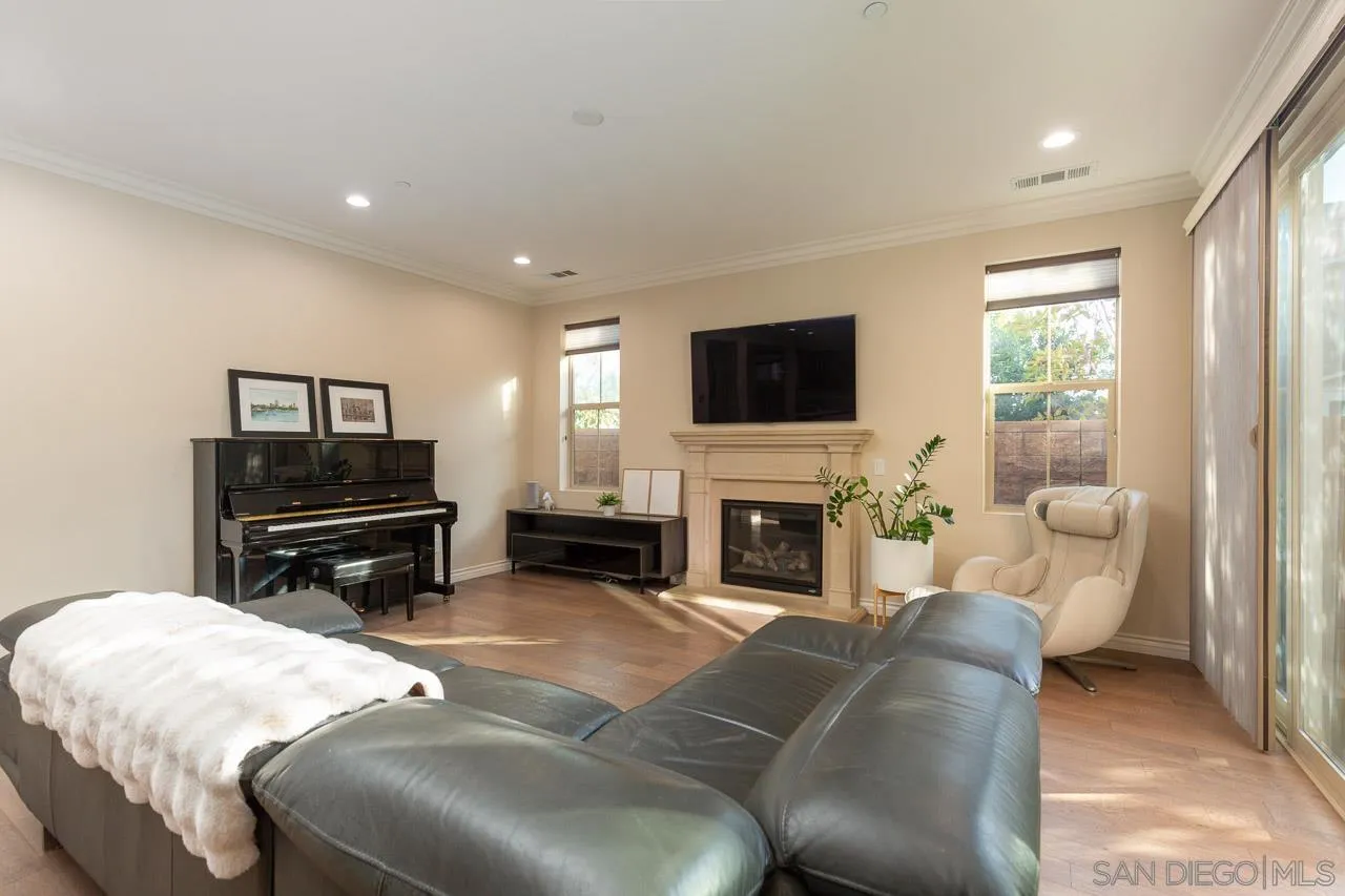 15622 Potomac Ridge Road San Diego, CA 92127 - Photo 7 of 49 a living room with furniture a fireplace and a flat screen tv