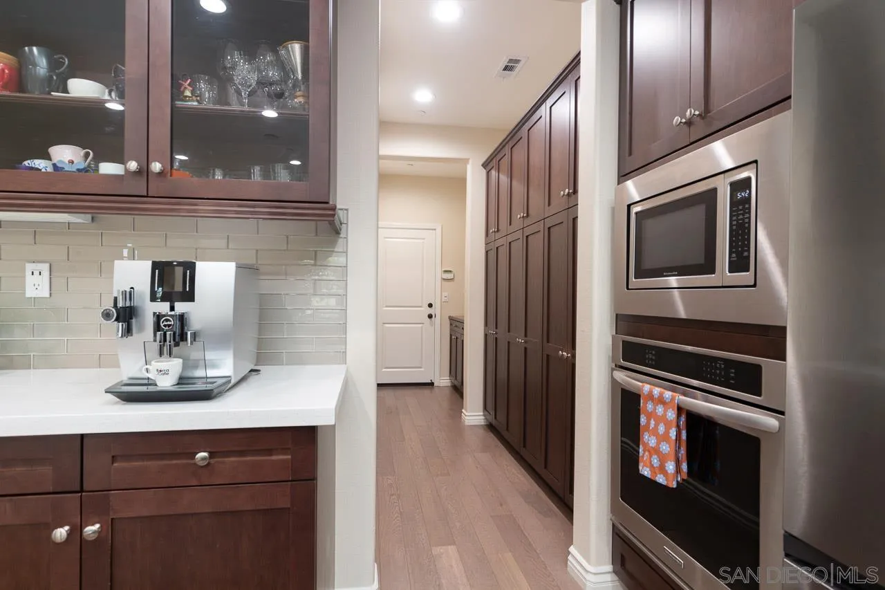 15622 Potomac Ridge Road San Diego, CA 92127 - Photo 8 of 49 a kitchen with a refrigerator and cabinets