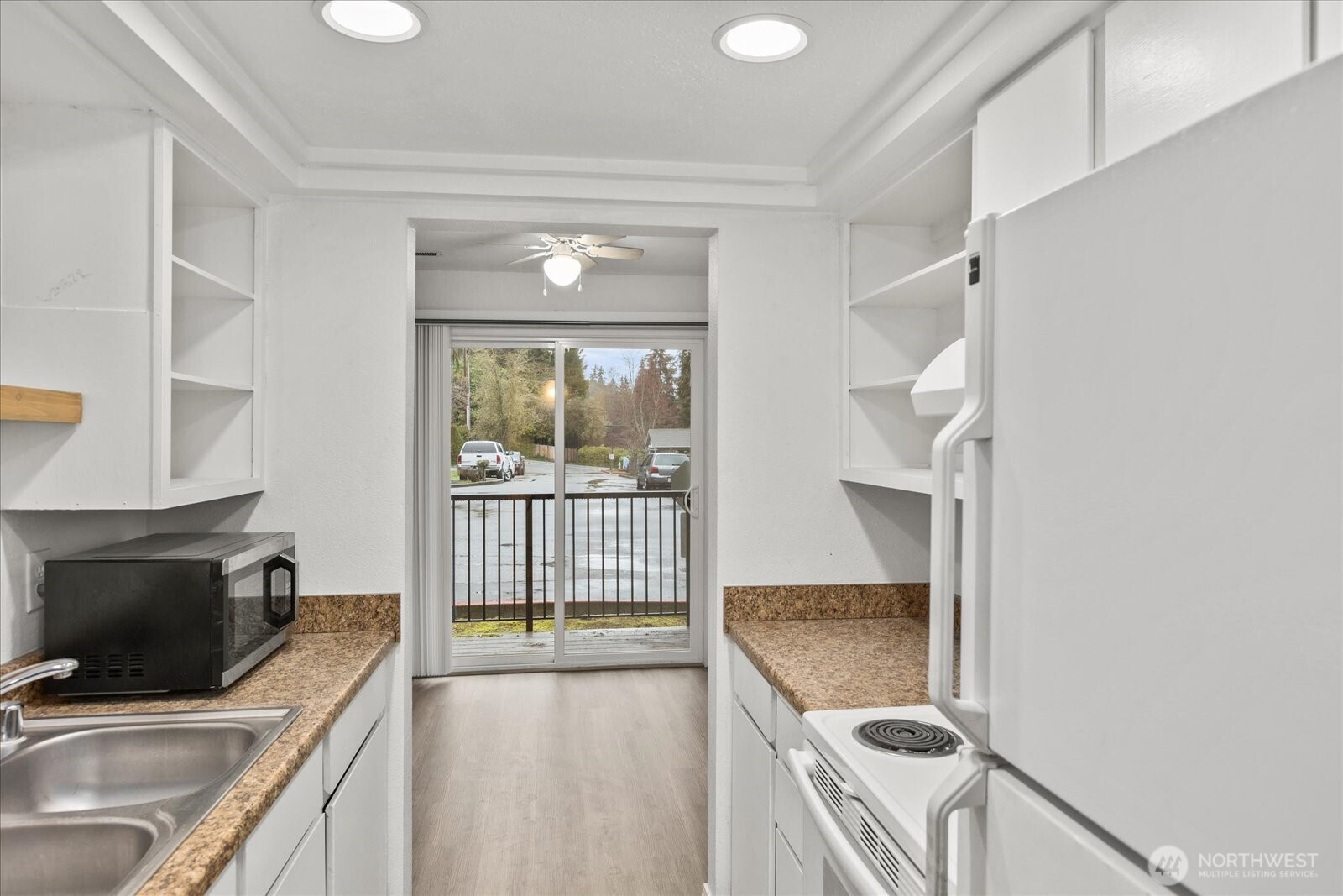a kitchen with a sink a stove and a microwave